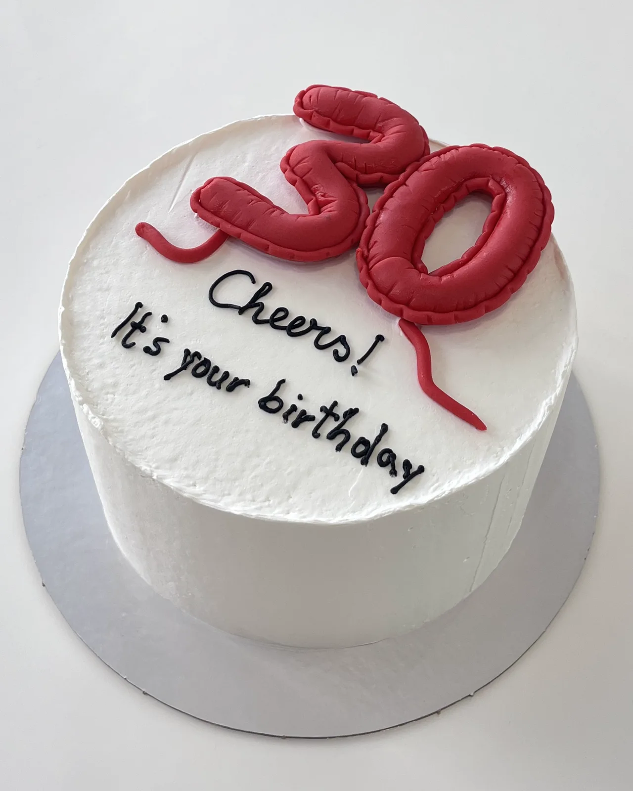 Minimal white 30th birthday cake with red balloon numbers, a custom cake by Cakes By Vjollca in Pristina, Kosovo