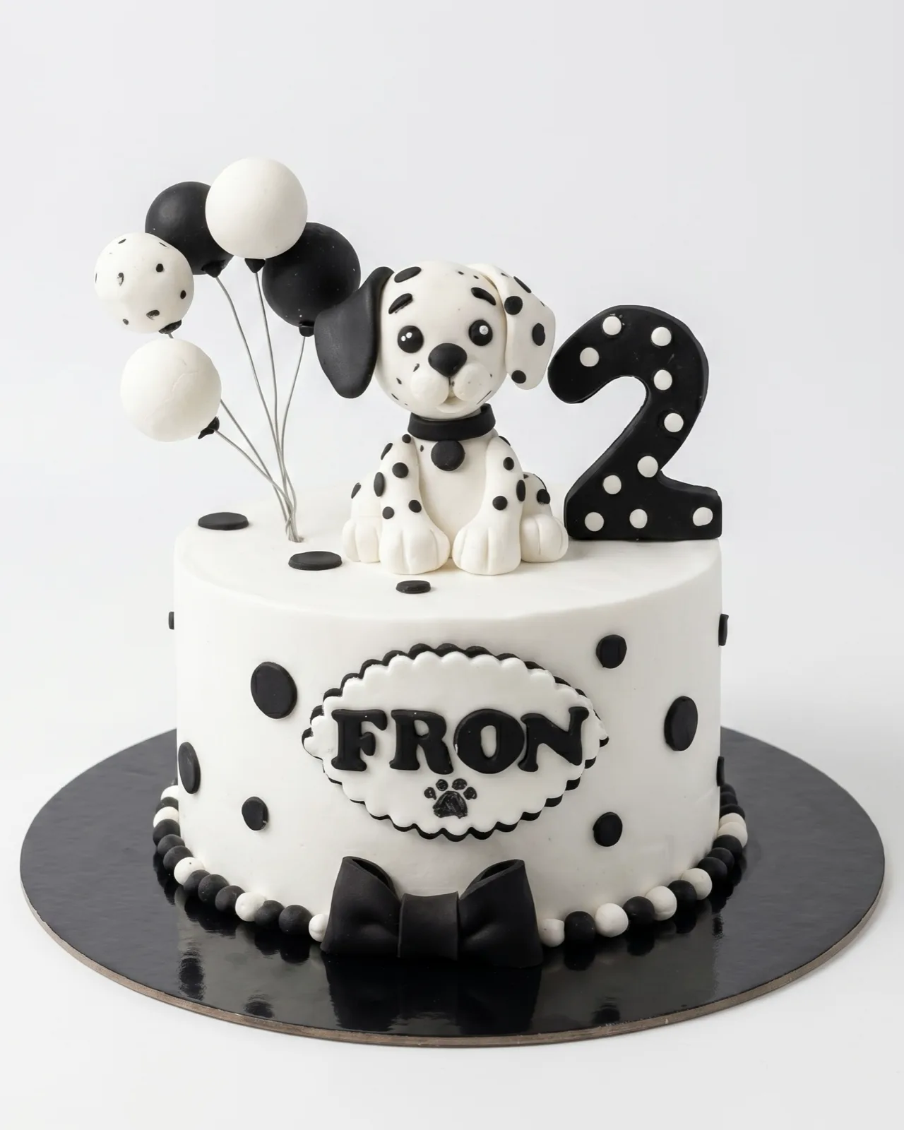 Black and white dalmatian puppy birthday cake with polka dots and balloons, a custom cake by Cakes By Vjollca in Pristina, Kosovo