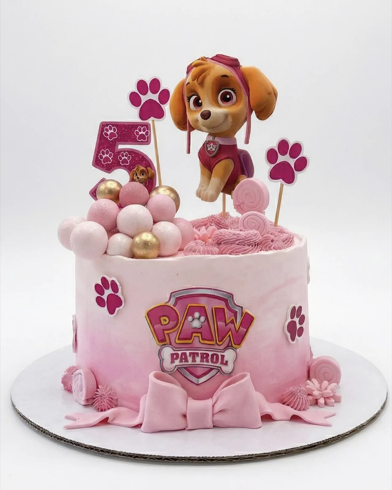 Pink Skye Paw Patrol birthday cake with paw prints and bubbles, a custom cake by Cakes By Vjollca in Pristina, Kosovo