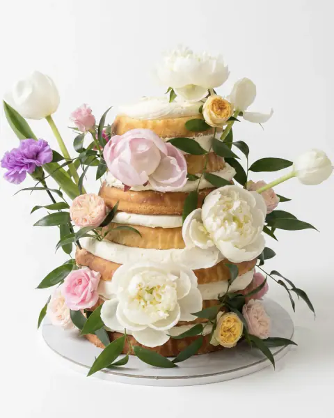 Naked-style engagement cake layered with fresh peonies, roses and tulips, a custom cake by Cakes By Vjollca in Pristina, Kosovo
